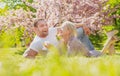 Happy spring couple in love having fun. Beautiful smiling young lovers enjoying flowering garden. Royalty Free Stock Photo