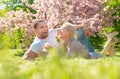 Happy spring couple in love having fun. Beautiful smiling young lovers enjoying flowering garden. Royalty Free Stock Photo