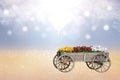Happy spring or greeting card composition. Closeup of decorative old big wooden cart or waggon with many colorful flowers over Royalty Free Stock Photo