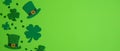 Happy St. Patrick`s Day banner design. Top view shamrock leaf clovers and Irish elf hats on green background. Saint Patricks Day Royalty Free Stock Photo