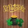Happy St. Patrick s day calligraphy hand lettering, Leprechaun s hat, clover and pot of golden coins on wood background. Saint Royalty Free Stock Photo