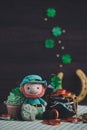 Happy St. Patrick`s day. Pot of golds, leprechaun and Irish green butter cupcake. Vintage film grained filter Royalty Free Stock Photo