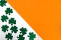 Happy St. PatrickÃ¢â¬â¢s Day. Shamrocks pattern on white and orange background.