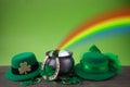 Happy St. Patrick's day. Shiny shamrocks, gold coins and leprechaun hat on a wooden background Royalty Free Stock Photo
