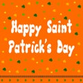 Happy St. Patrick\'s Day written in english in white with green clovers on orange background