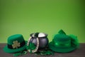 Happy St. Patrick's day. Shiny shamrocks, gold coins and leprechaun hat on a wooden background Royalty Free Stock Photo