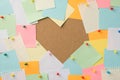 Happy St Valentines day concept. Photo of stack of multicolored stickers attached to the board making heart with blank empty space