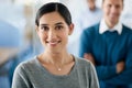 Happy staff make happier clients. Portrait of a beautiful businesswoman standing in front of her colleagues in an office Royalty Free Stock Photo