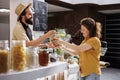 Happy store vendor sells pasta Royalty Free Stock Photo