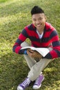 Happy Student with book on lawn