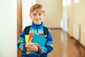 Happy student boy with backpack at school. Schoolboy holding books Royalty Free Stock Photo