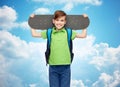 Happy student boy with backpack and skateboard Royalty Free Stock Photo