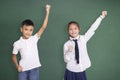 Happy student boy and girl raising hand Royalty Free Stock Photo