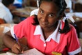 A happy student completing work at Mulomulo Primary School in Fiji.