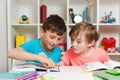 Happy student doing test in primary school. Children writing notes in classroom. School boys doing homework together Royalty Free Stock Photo