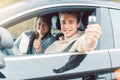 Happy student of driving school showing car keys