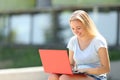 Happy student e-learning using laptop outdoors Royalty Free Stock Photo