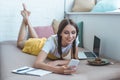 happy student with earphones and laptop writing Royalty Free Stock Photo