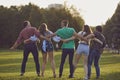 Happy student friends spending time together outdoors. Young hipsters having great time in countryside Royalty Free Stock Photo