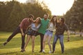 Happy student friends spending time together outdoors. Young hipsters having great time in countryside Royalty Free Stock Photo