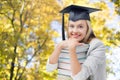 Happy student girl in bachelor cap with books Royalty Free Stock Photo