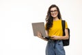 Happy student girl with backpack standing and holding laptop isolated on a white background Royalty Free Stock Photo