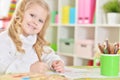 Portrait of happy girl drawing with colorful pencils Royalty Free Stock Photo