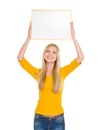 Happy student girl holding blank board over head Royalty Free Stock Photo