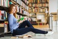 Happy student girl reading book in library Royalty Free Stock Photo