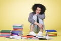 Happy student girl reading surrounded by colorful books. Royalty Free Stock Photo