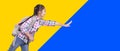 Happy student girl with school bag. Running and touching something. Isolated on yellow and blue background