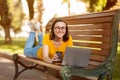Happy Student Girl Using Laptop Lying On Bench Outdoor Royalty Free Stock Photo