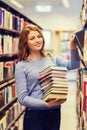 Happy student girl or woman with books in library Royalty Free Stock Photo