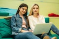 Happy student have a break in university. Have a good time while using phone , tablet and laptop. Two girls Royalty Free Stock Photo