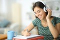 Happy student with headphone studying listening audio guide Royalty Free Stock Photo