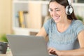 Happy student with headphones and laptop e-learning Royalty Free Stock Photo