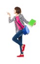 Happy student holding books and showing something Royalty Free Stock Photo