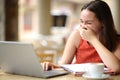 Happy student laughing loud watching media on laptop