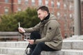 Happy student man reads approval letter after college exams or job offer sitting in campus. Royalty Free Stock Photo