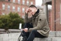 Happy student man reads approval letter after college exams or job offer sitting in campus. Royalty Free Stock Photo