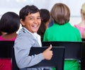 Happy student, portrait and boy with thumbs up in class for winning, good job or success at school. Young male person Royalty Free Stock Photo