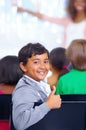 Happy student, portrait and child with thumbs up in class for winning or success at school. Young male person, boy or Royalty Free Stock Photo