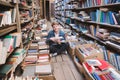 Happy student sitting on the floor in an old public library and busy self-education Royalty Free Stock Photo