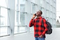 Happy student talking on mobile phone at rail station Royalty Free Stock Photo