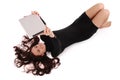 Happy student teenage girl lying on the floor looking at tablet Royalty Free Stock Photo