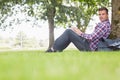 Happy student using his laptop to study outside Royalty Free Stock Photo