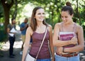 Happy, student and walking on campus with education, learning and books for knowledge in university. Young women or Royalty Free Stock Photo