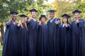 Happy students or bachelors showing thumbs up Royalty Free Stock Photo