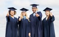 Happy students or bachelors showing thumbs up Royalty Free Stock Photo