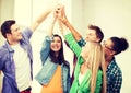 Happy students giving high five at school Royalty Free Stock Photo